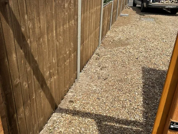 Closeboard fence with concrete posts and gravel boards