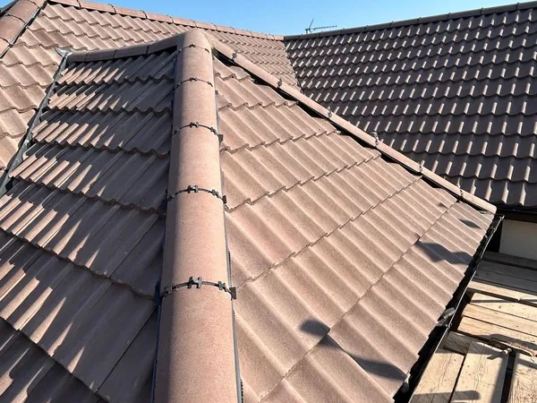 New ridge tiles bedded and fixed