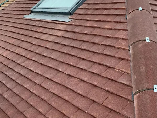 Repaired tiled roof with roof window